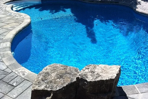 Stone coping on a vinyl liner pool